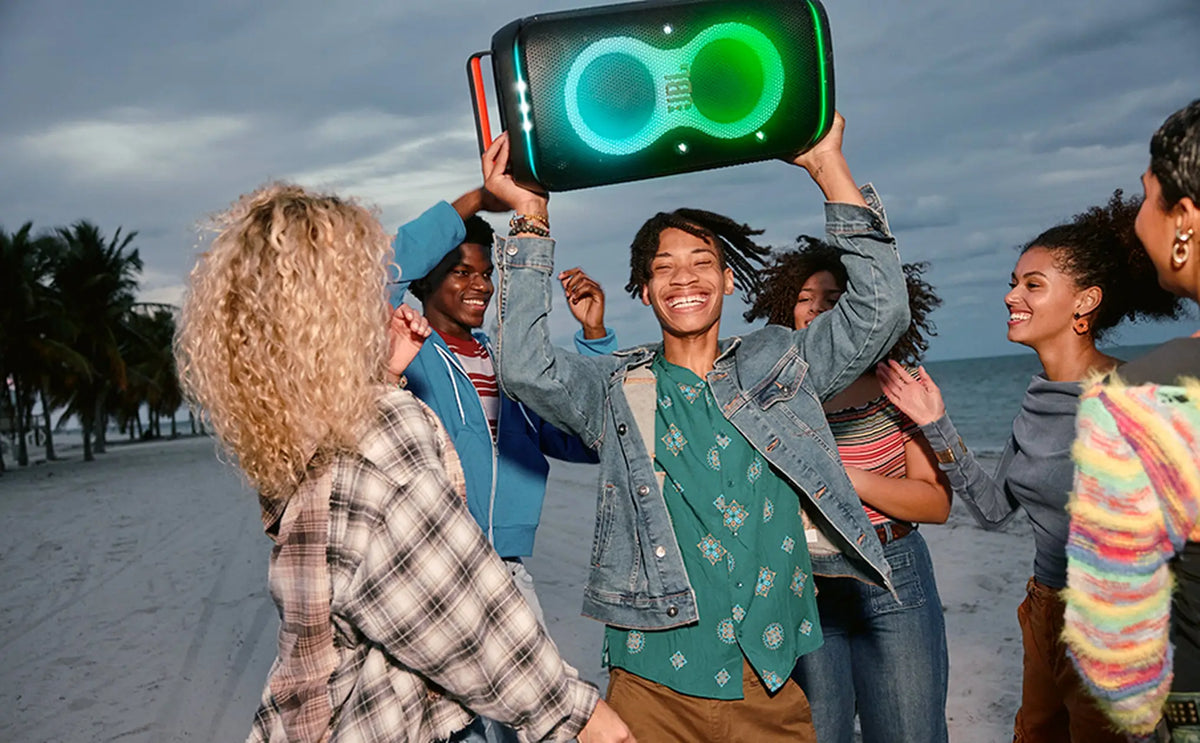 Group enjoying JBL PartyBox Club 120 at the beach