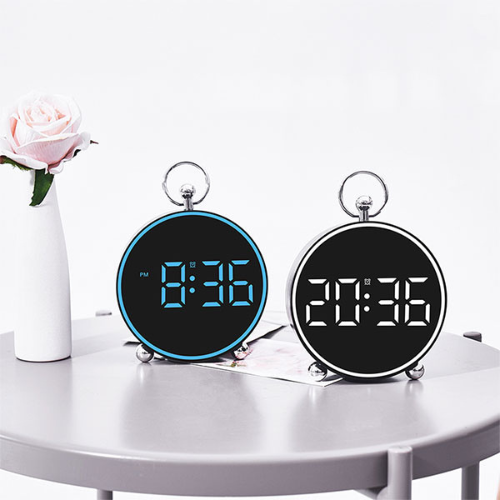 Two digital clocks on a table with a white background