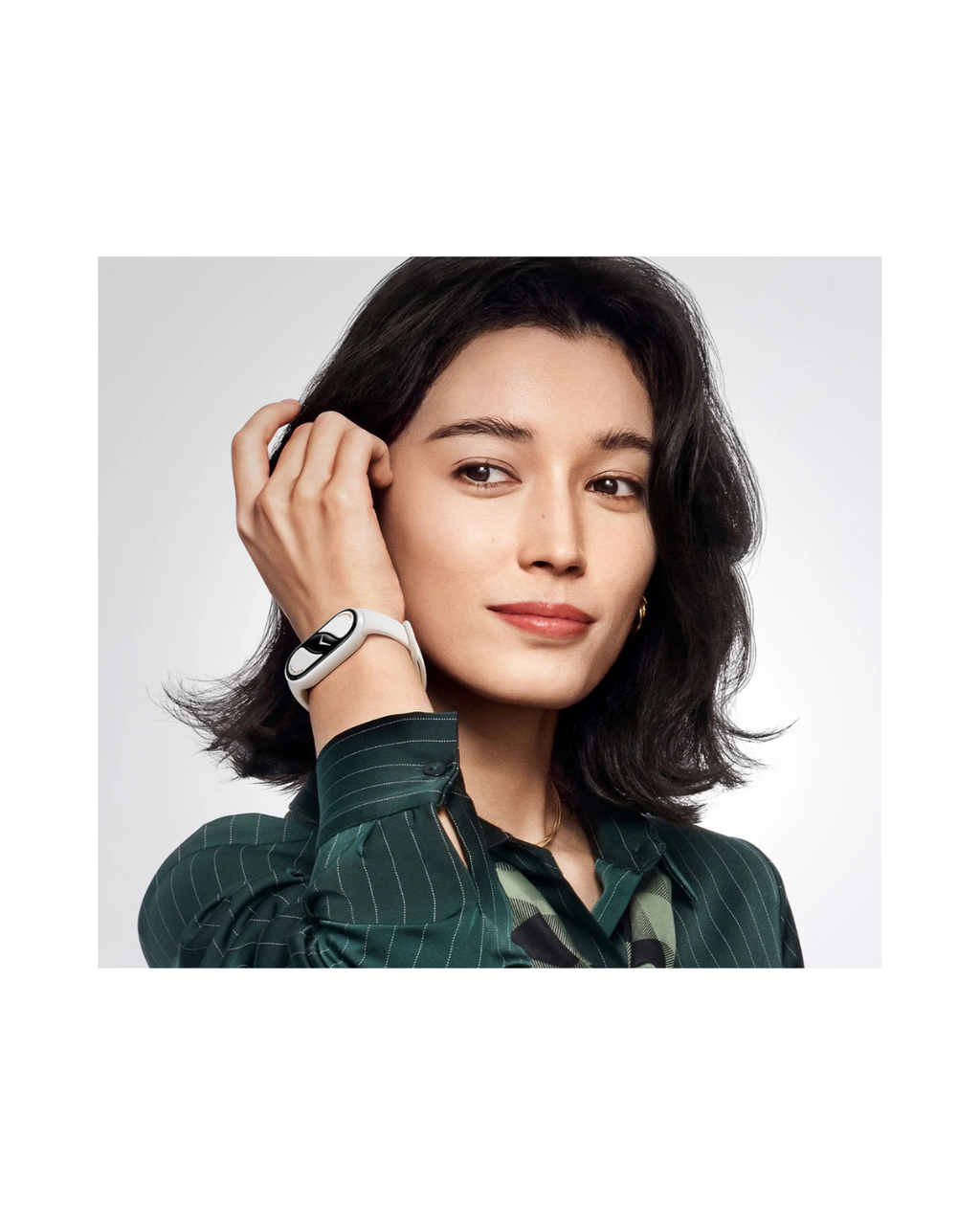 Woman wearing a smartwatch on a plain background